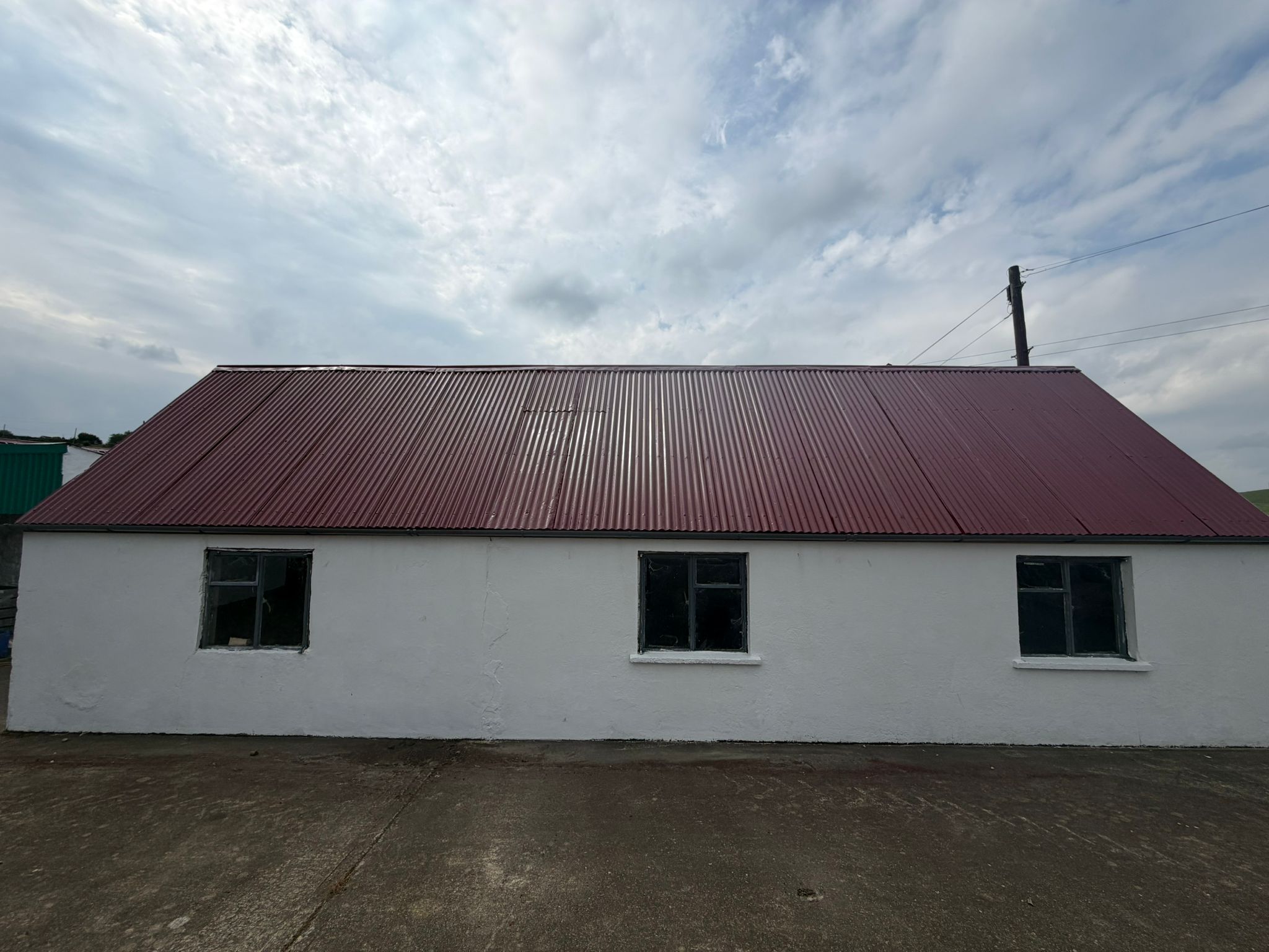 Resprayed tin roof on traditional whitewashed building